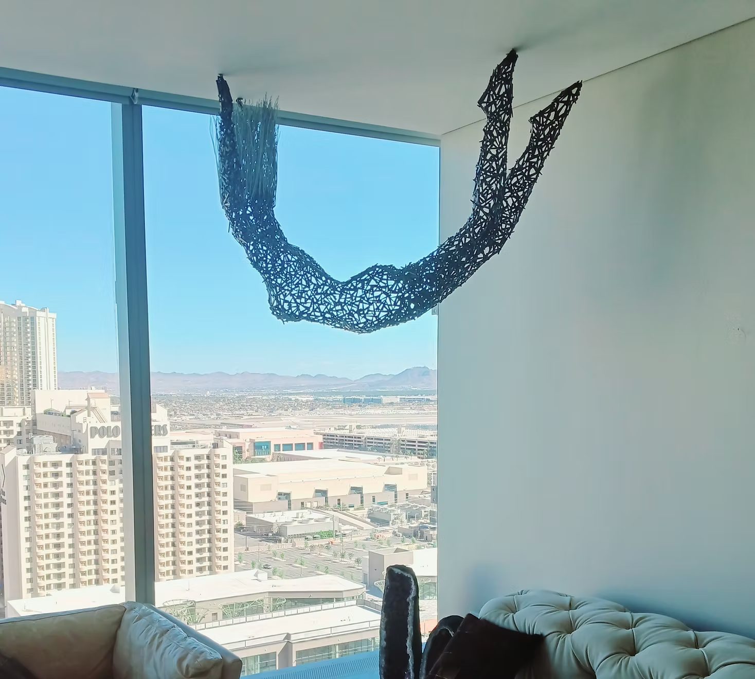 Installed sculpture in a high-rise residence Custom welded metal sculpture by Corey Ellis suspended in a Las Vegas high-rise residence overlooking the city skyline