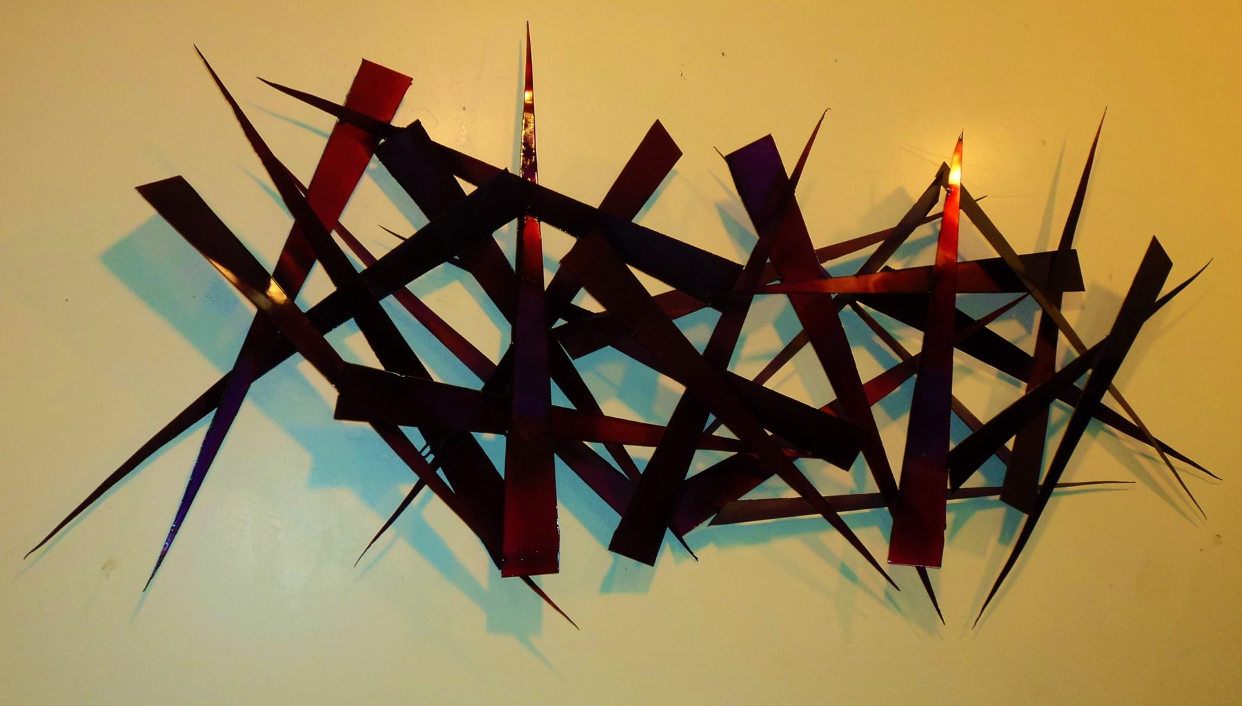 Breaking Charity Breaking Charity - large-scale welded steel wall sculpture by Corey Ellis with red and amber patina